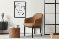Stylish scandinavian composition of living room with design armchair, black mock up poster frame, commode, wooden stool, book, decoration, loft wall and personal accessories in modern home decor.